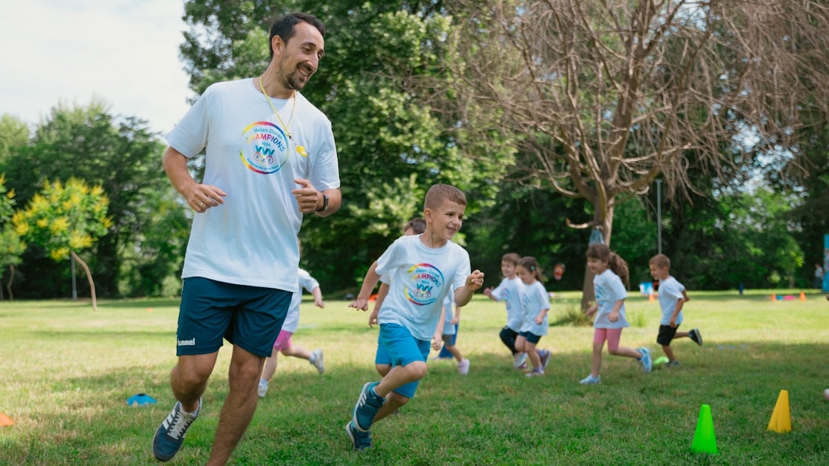 a group of people running around a field